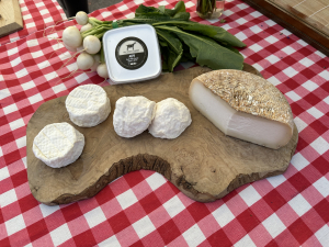 Goat cheese displayed on a wood board