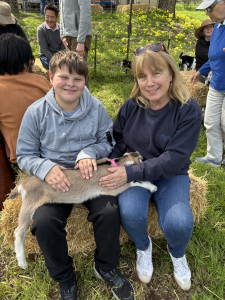 Visitors petting a baby goat