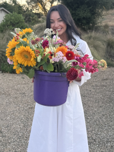 Woman holding a bouquet of colorful flowers